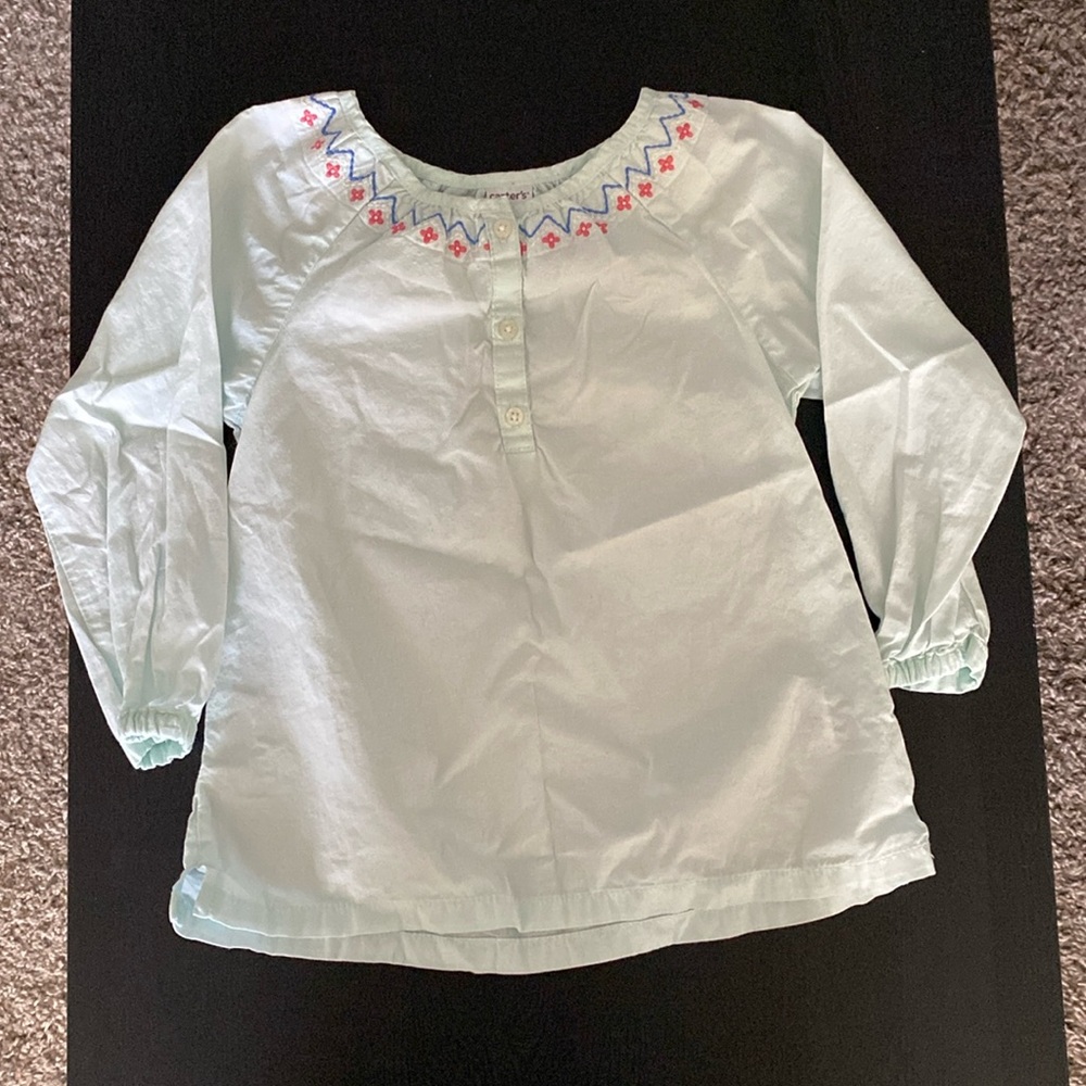 Teal long sleeve shirt for infant girl.